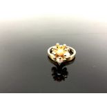 A 9ct yellow gold ring set with coral and pearl, size K, 3.4g.