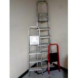 A seven step aluminium folding ladder together with two further pairs of folding steps