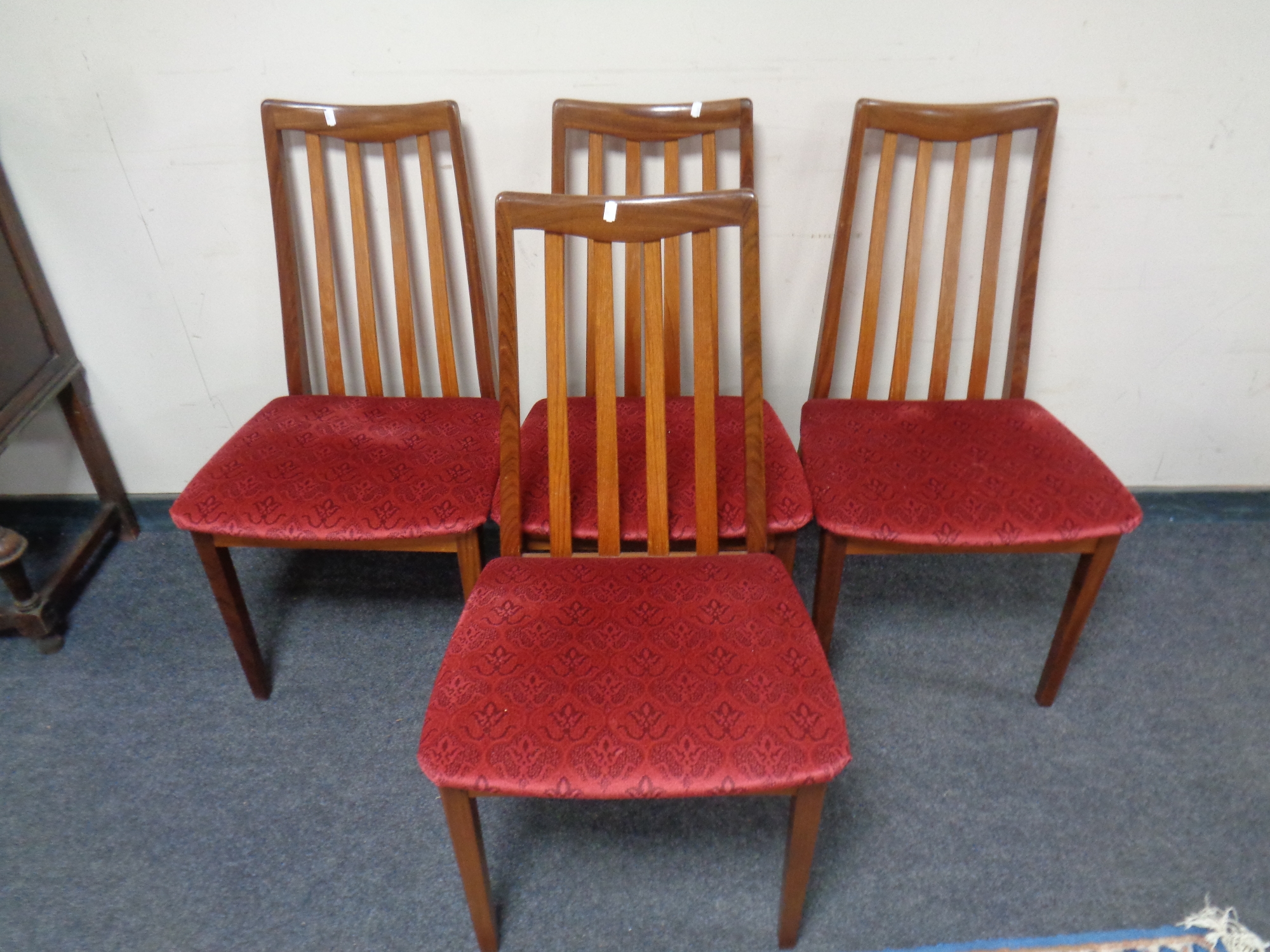 A set of four twentieth century teak G-plan rail backed chairs