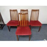 A set of four twentieth century teak G-plan rail backed chairs