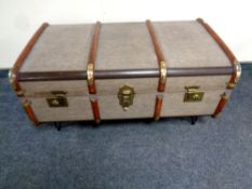 A bentwood bound steamer trunk on metal hairpin legs