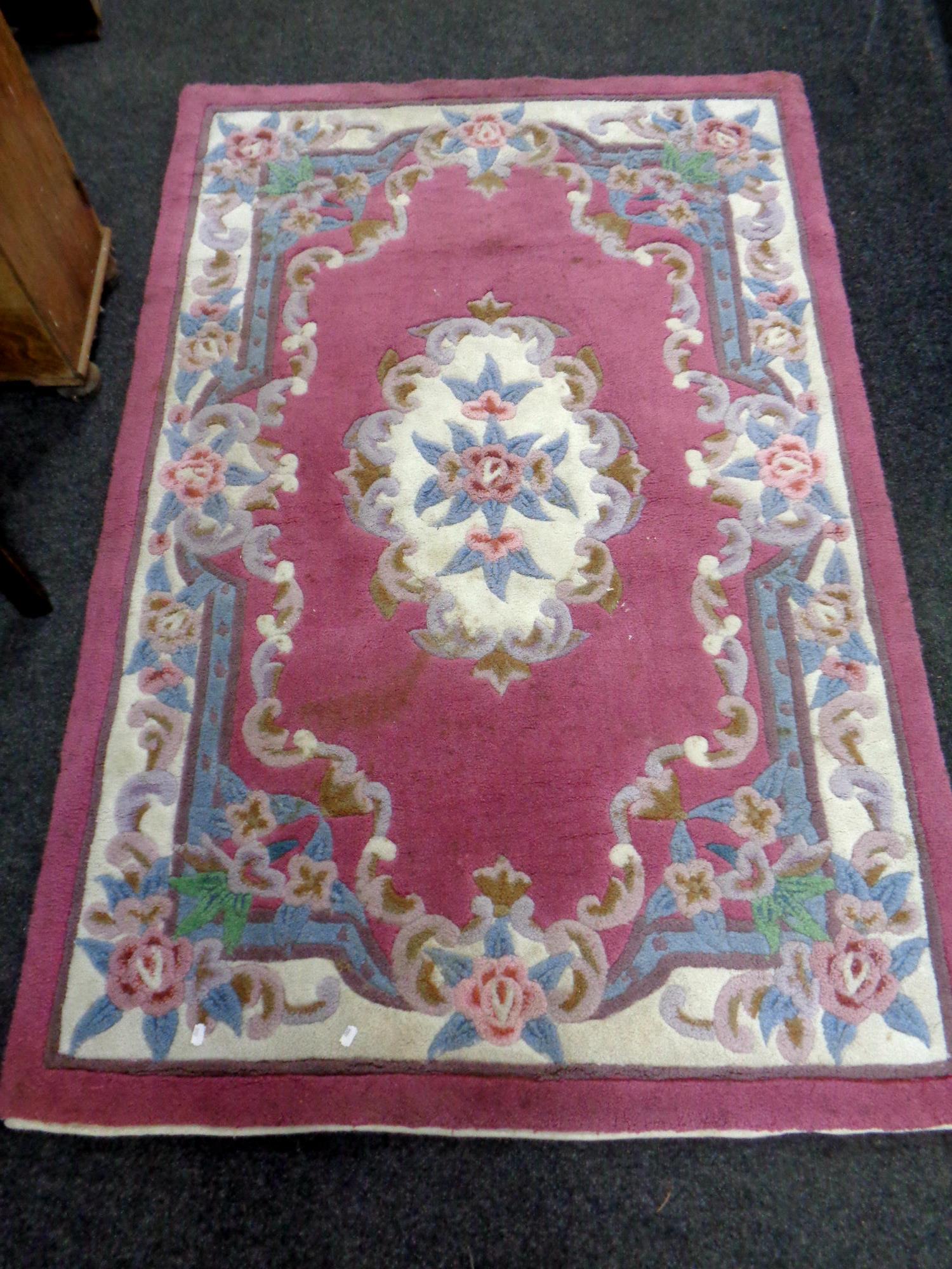 A Chinese floral patterned rug on pink ground