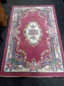 A Chinese floral patterned rug on pink ground