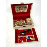 A jewellery box containing costume jewellery,