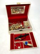 A jewellery box containing costume jewellery,