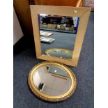 An oval gilt framed bevelled mirror together with a further mirror