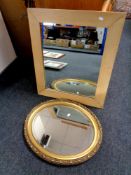 An oval gilt framed bevelled mirror together with a further mirror