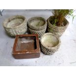 Four concrete garden planters together with a further salt glazed trough