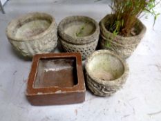 Four concrete garden planters together with a further salt glazed trough