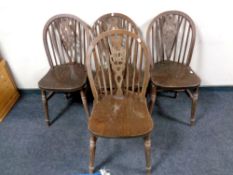 A set of four oak wheel backed chairs