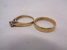 A 9ct gold lady's dress ring together with a 9ct gold wedding band