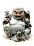 A Chinese figure - Buddha with children, impressed mark to base, height 20 cm.