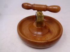 A vintage wood and brass nut cracker bowl