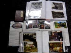 A box containing five postcard albums