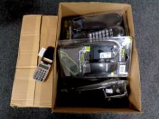 Two boxes containing 12 slim line home telephones together with 100 calculators with clocks (new