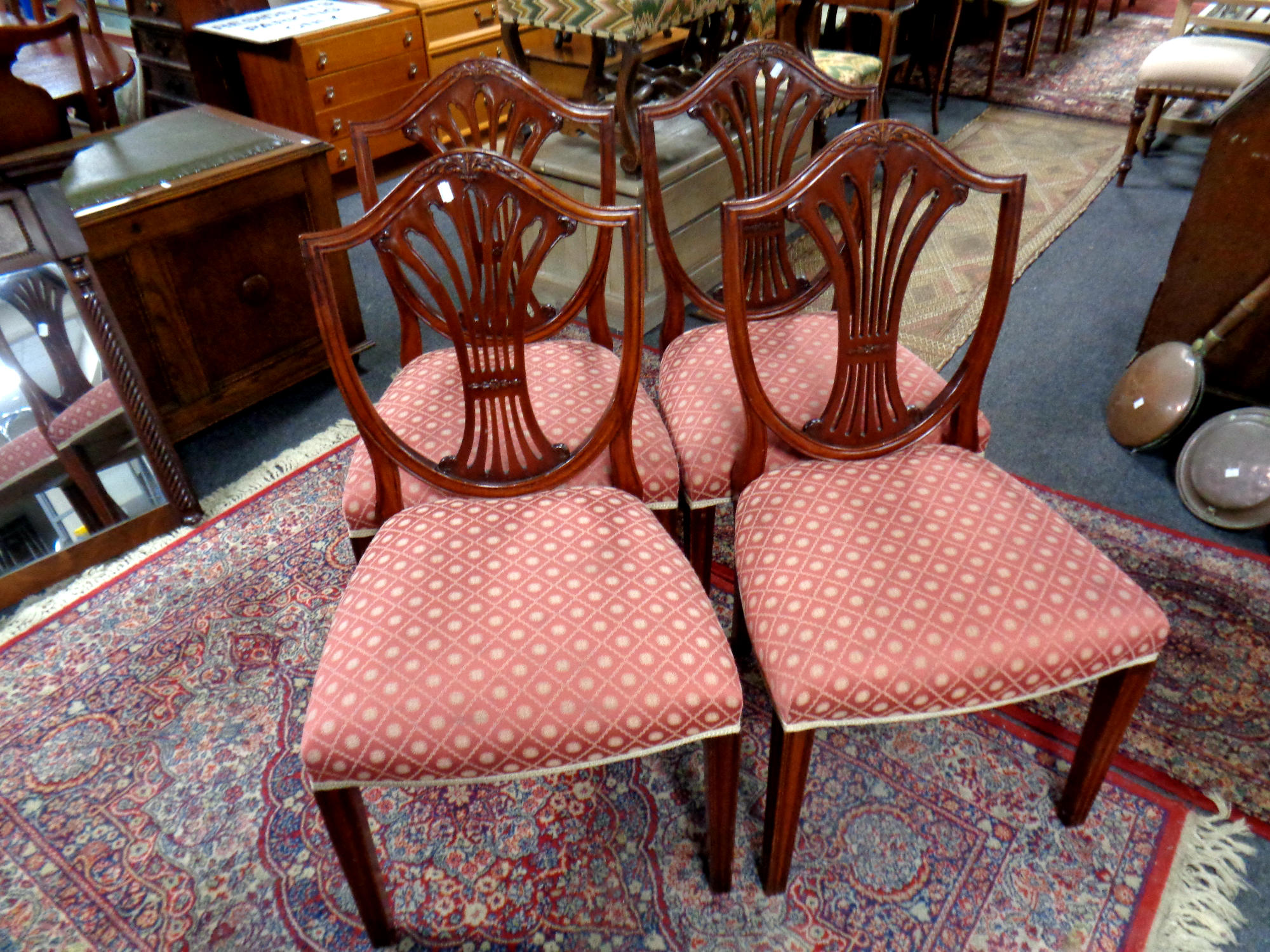 A set of four reproduction shield backed chairs