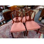 A set of four reproduction shield backed chairs