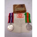 Two WWII medals on ribbons; War Medal and Defence medal, in box of issue addressed to T Yuill Esq.