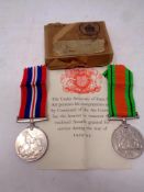 Two WWII medals on ribbons; War Medal and Defence medal, in box of issue addressed to T Yuill Esq.