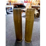 Two large brass shell casings,