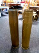 Two large brass shell casings,