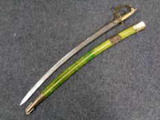 An Indian brass handled sword in sheath