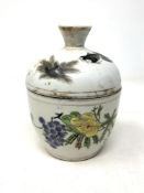 A Chinese lidded pot decorated with floral panels and birds, red character mark to base, rubbed,