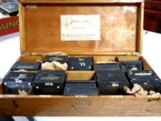A wooden box containing glass turbine slides from Brush Engineering Company