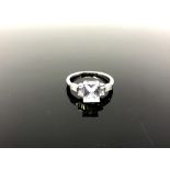 An Art Deco style silver ring set with a clear stone,