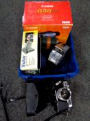 A basket of Canon and Vivitar digital video cameras, Halina super 8 camera,