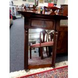 A Victorian mahogany wall mirror with pillar column supports