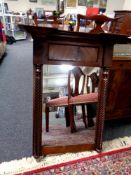 A Victorian mahogany wall mirror with pillar column supports