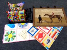 A crate of patchwork throws, wall hanging depicting man on horse,