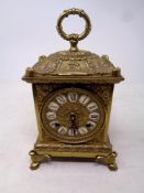 A decorative German gilt metal carriage clock on raised feet