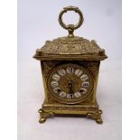 A decorative German gilt metal carriage clock on raised feet