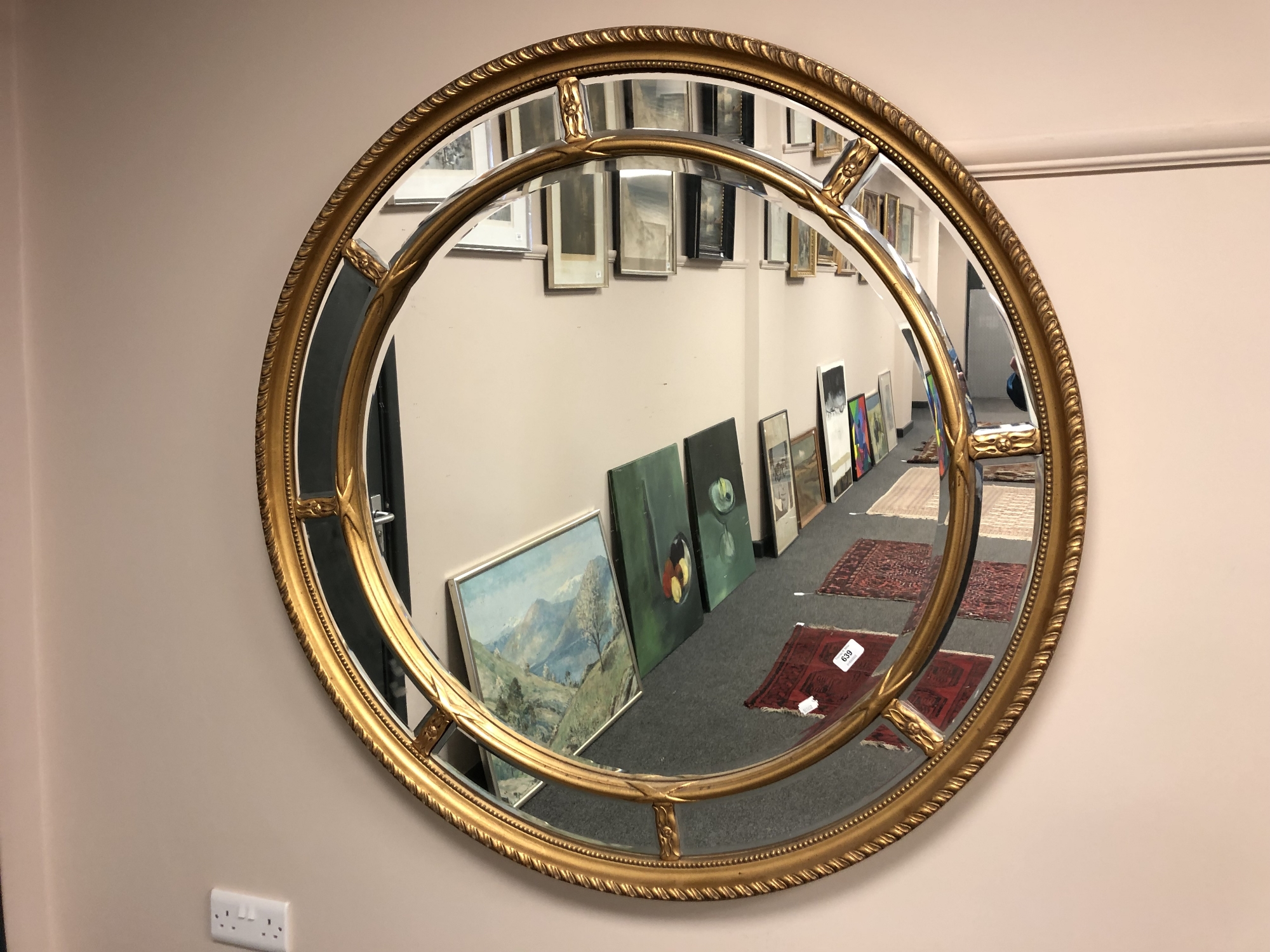 An ornate gilt-framed circular mirror,