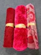 A contemporary shaggy pile rug together with two further rugs (pink)
