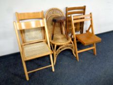 A wicker occasional chair together with a milking stool and two pairs of folding kitchen chairs