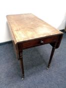 A Victorian mahogany flap sided table fitted a drawer