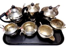 A tray containing a four piece plated tea service together with a three piece plated tea service