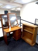 A contemporary pine three drawer dressing table together with shelves,