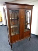 A nineteenth century inlaid mahogany double door display cabinet