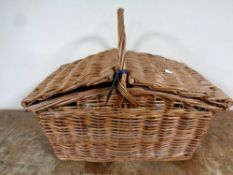 A twentieth century wicker picnic hamper with contents