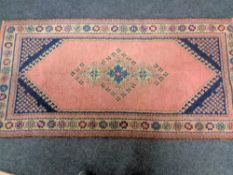 An eastern woolen rug 83 cm x 166 cm