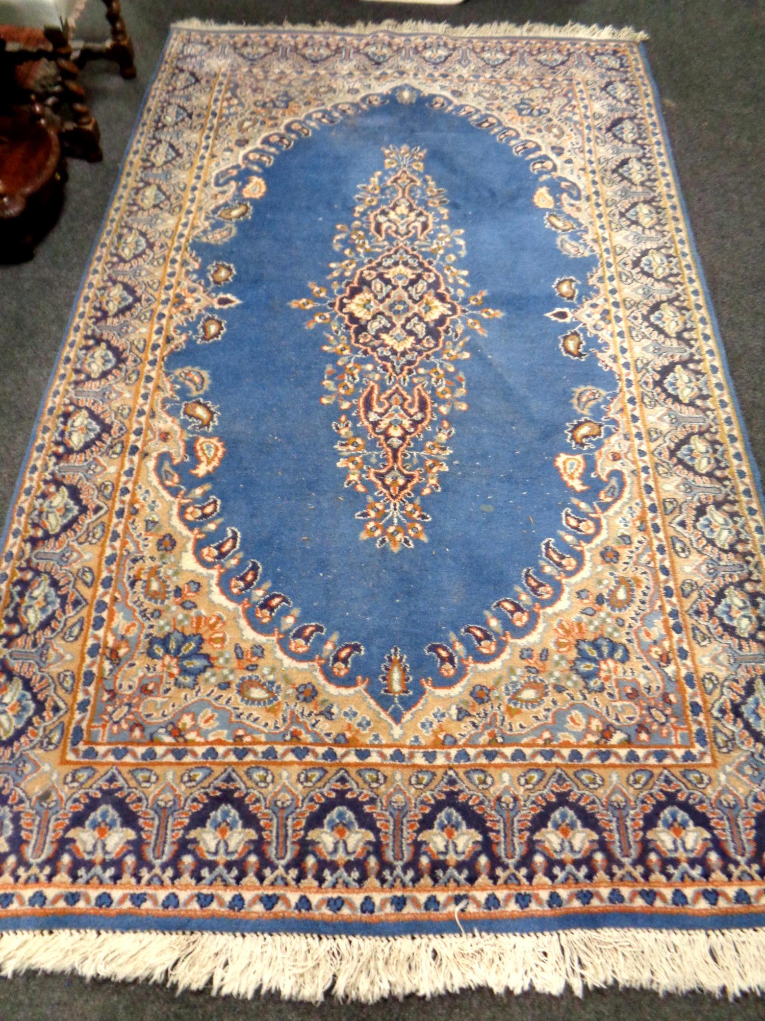 An Iranian fringed rug on blue ground,