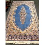 An Iranian fringed rug on blue ground,