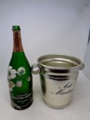 A Perrier Jouet green glass champagne bottle in bucket