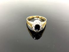A yellow gold diamond and sapphire cluster ring, size S/T, 4.7g.