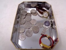 A tin of a collection of assorted crowns together with three wristwatches