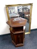 A bevelled mirror in gilt swept frame together with a hexagonal cabinet